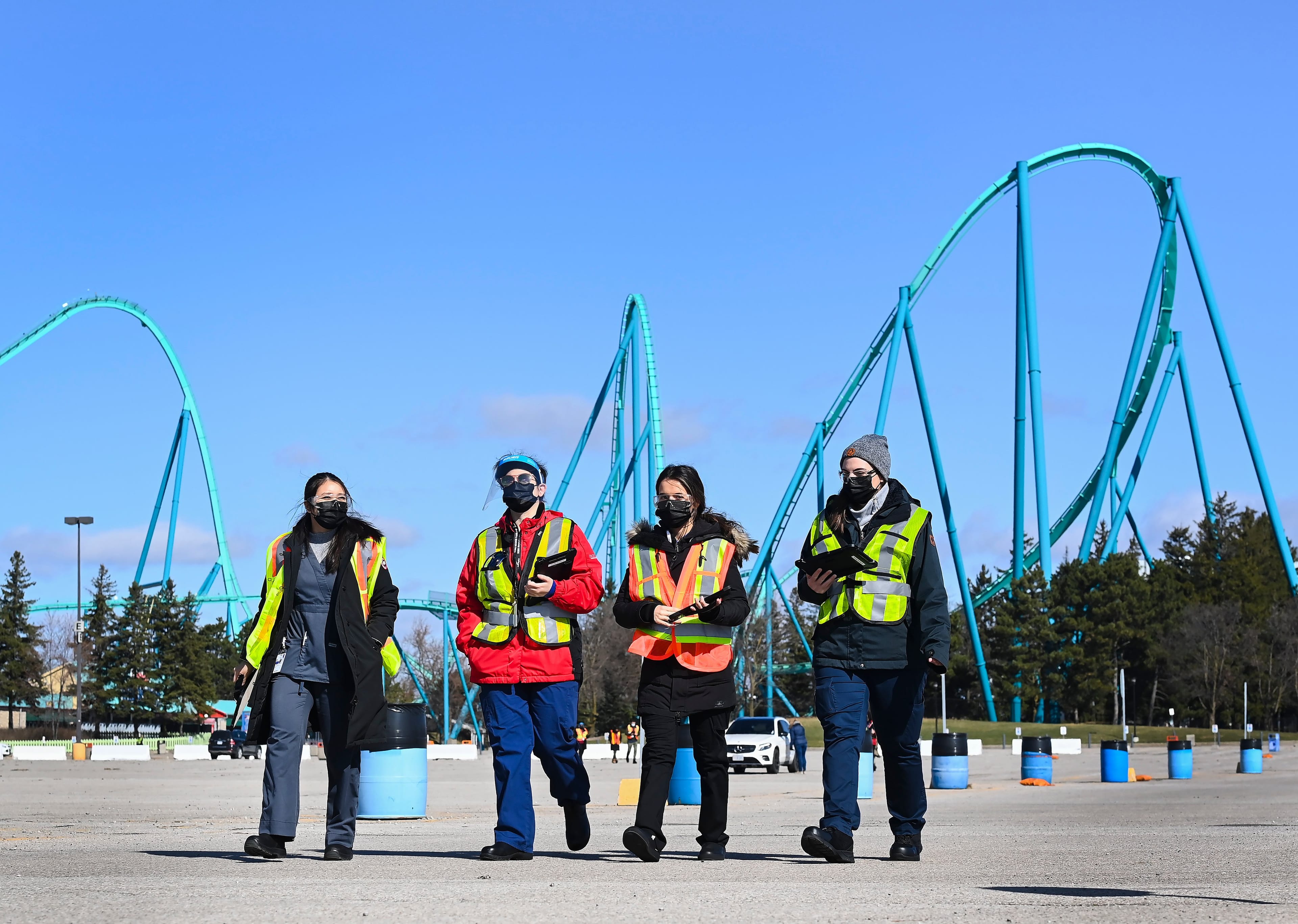 Health-care workers get ready to take patients at a drive-thru COVID-19 mass vaccination site at Canada's Wonderland during the COVID-19 pandemic in Vaughan, Ont., on Monday, March 29, 2021. People don't have to leave their vehicles to get their dose of the vaccine. THE CANADIAN PRESS/Nathan Denette