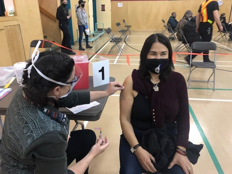 Pauline Frost receives her vaccine in Old Crow from Ann Chapman. (Courtesy of Pauline Frost)