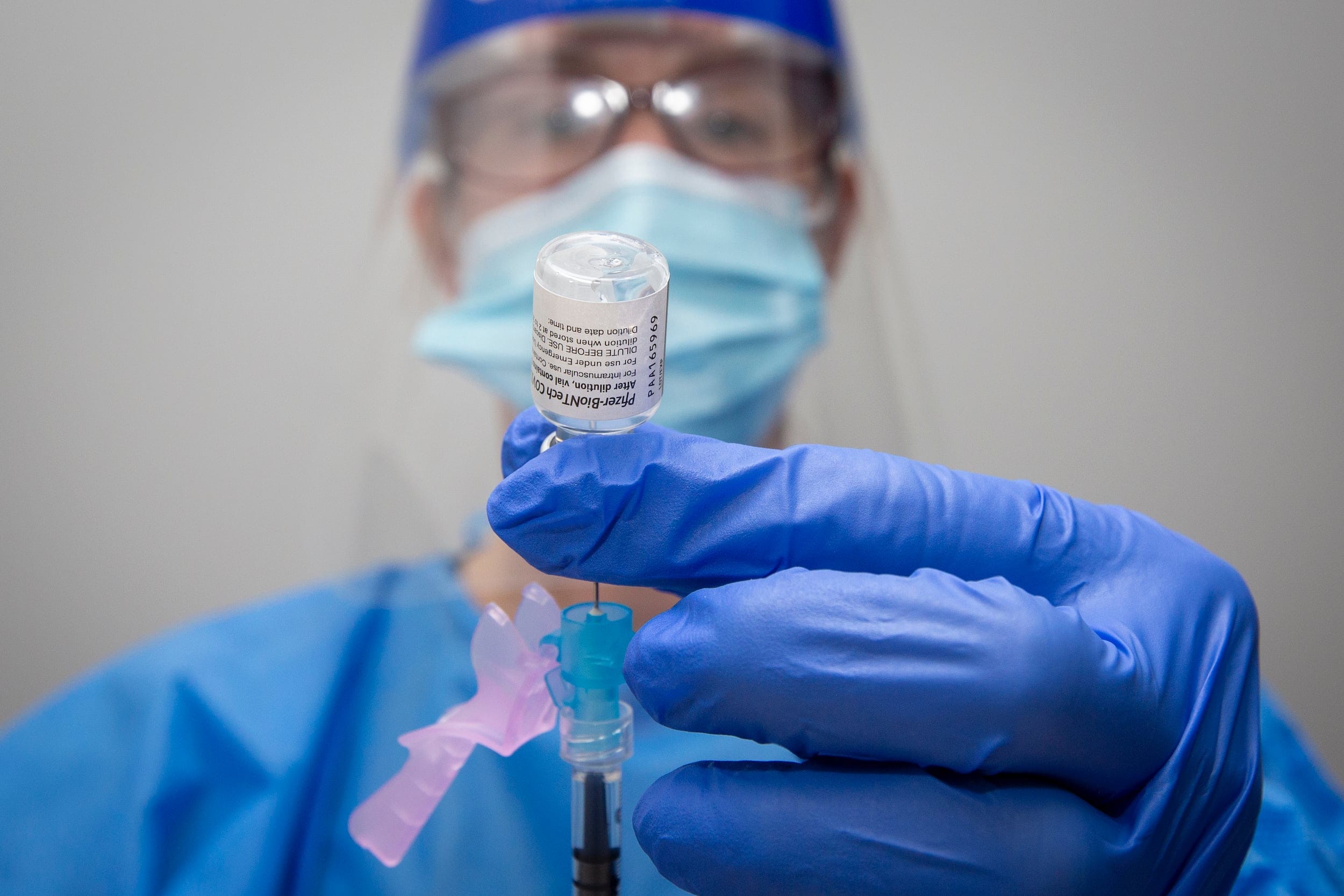 Pharmacist Suzanne Garrett draws a syringe with Pfizer-BioNTech covid-19 vaccine at a pharmacy in Amherstview, Ontario on Friday June 25, 2021. THE CANADIAN PRESS IMAGES/Lars Hagberg