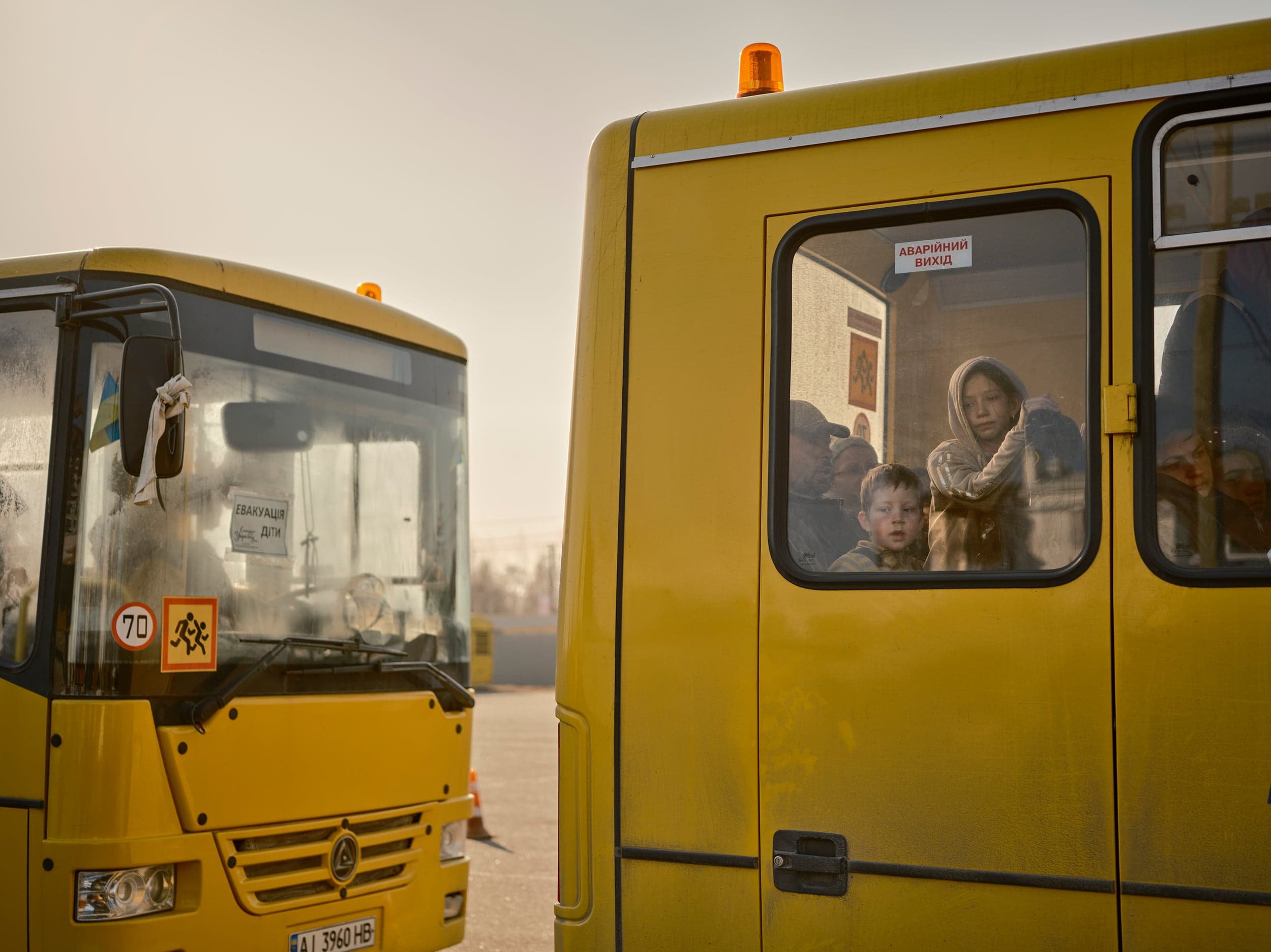 Bilohorodka, March 19. “A group of evacuation buses arrived from Bucha. There were about seven in total, and 10 per cent of the passengers were children. Before they disembarked, each person had their papers checked by police officers to make sure they weren’t spies. There have been a lot of problems with Russian saboteurs posing as internally displaced persons, getting into the cities and causing havoc. After they were cleared, passengers could get hot meals and warm clothes in the parking lot, then board buses to cities where their families lived.” (Photograph by Philip Cheung)