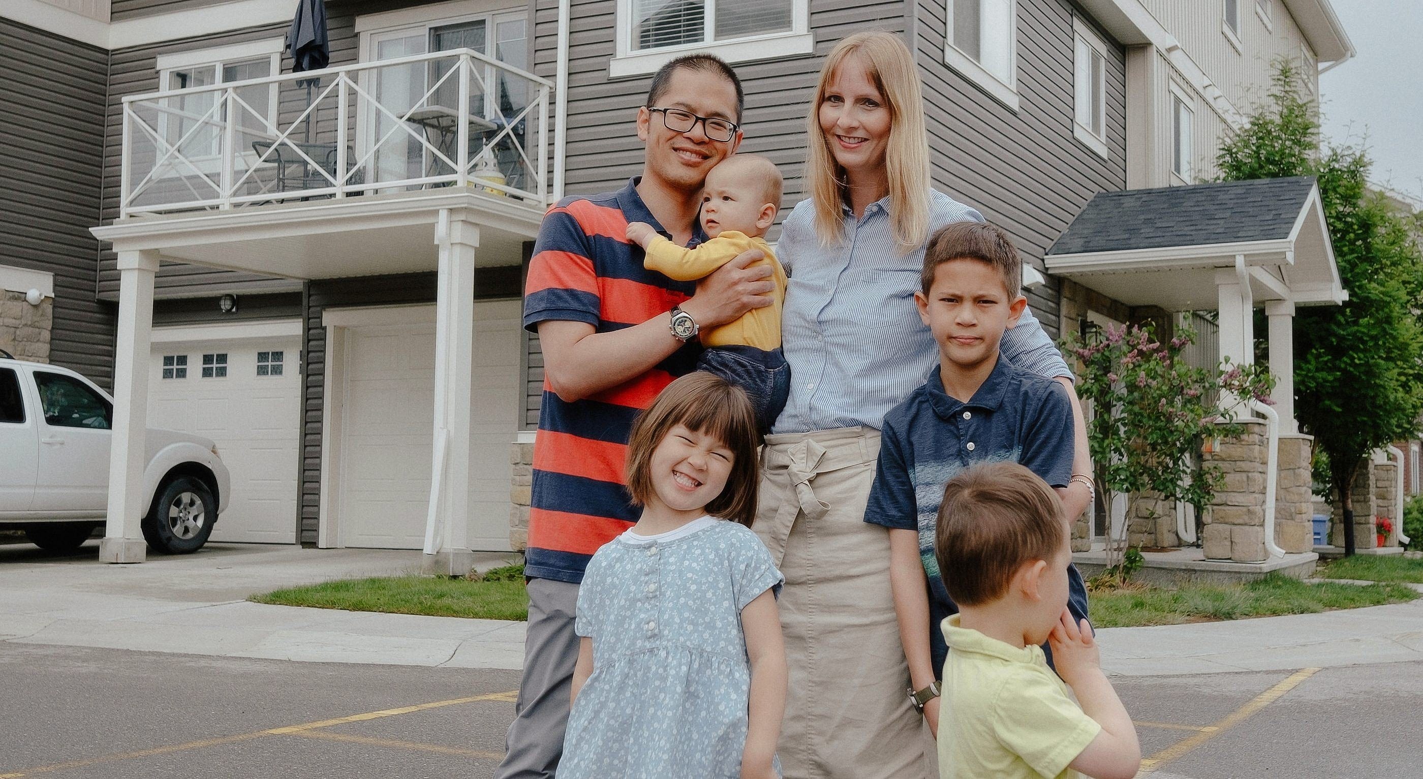 The Chiu family in front of their new three-bedroom, two-bathroom townhouse in Calgary, Alberta. (Photos courtesy Allison Seto)