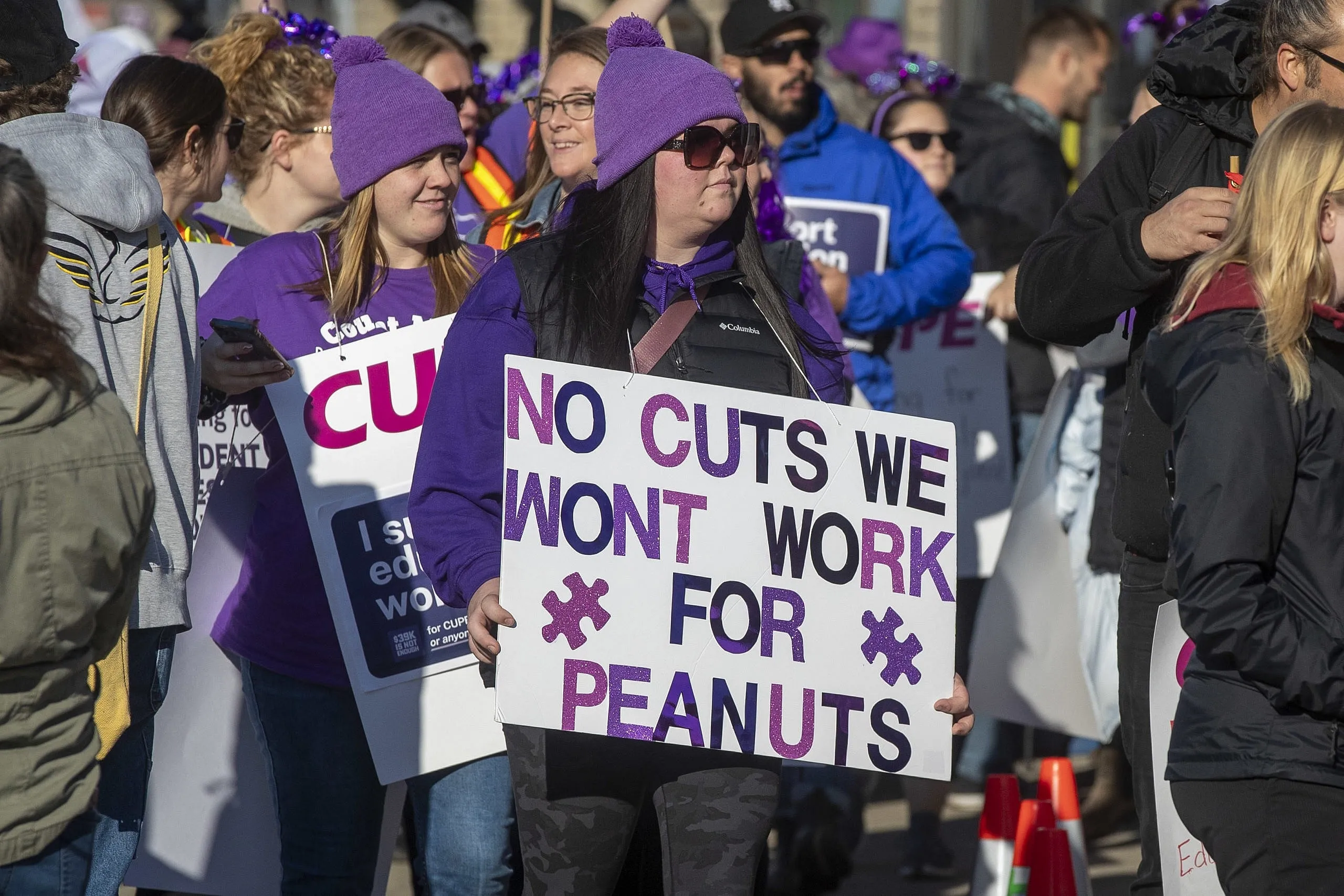 A group of workers striking with various signs