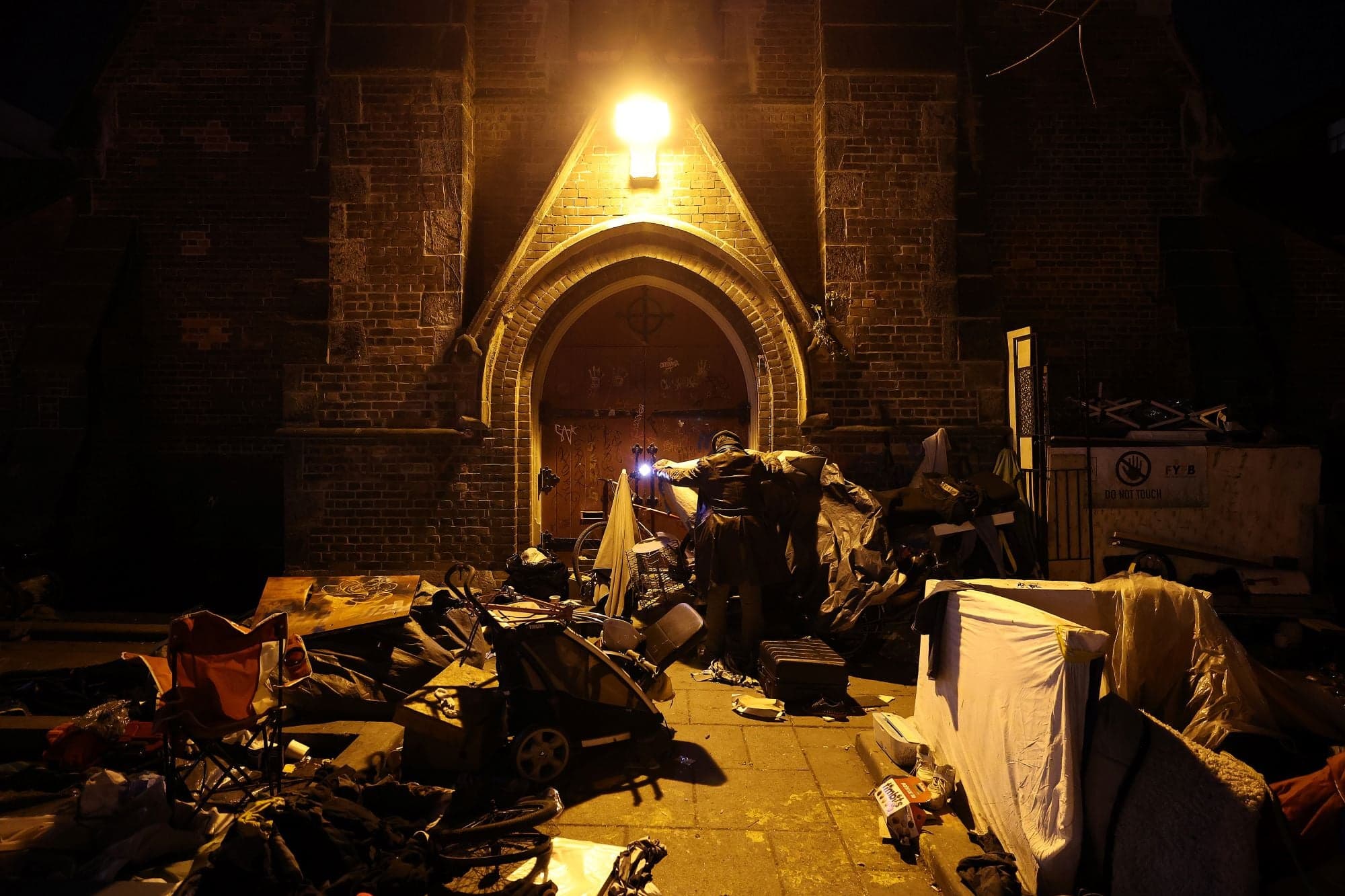A photo of a churchyard after dark, with debris littered on the ground