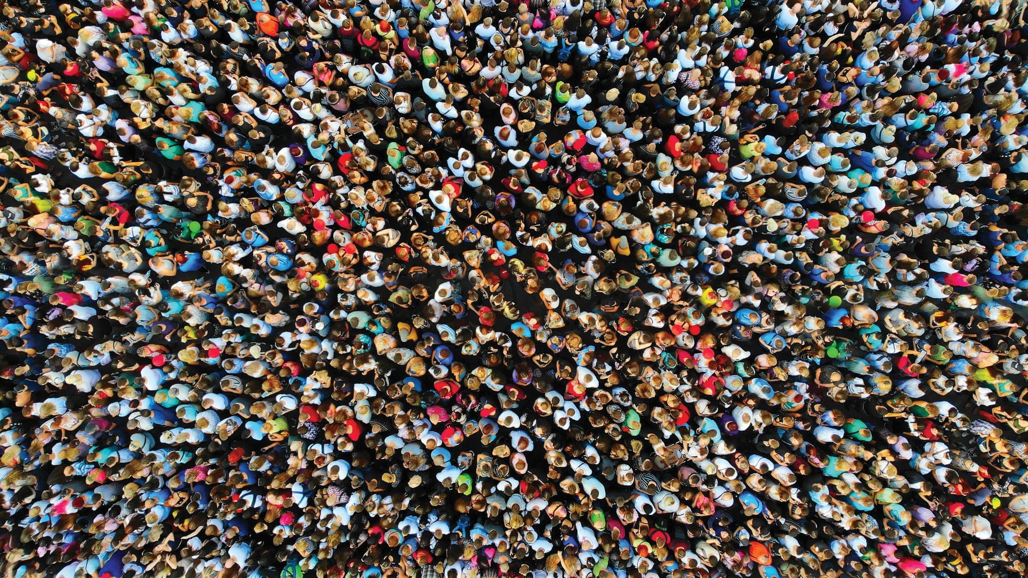Big crowd of people. People gathered together in one place. Top view from drone.