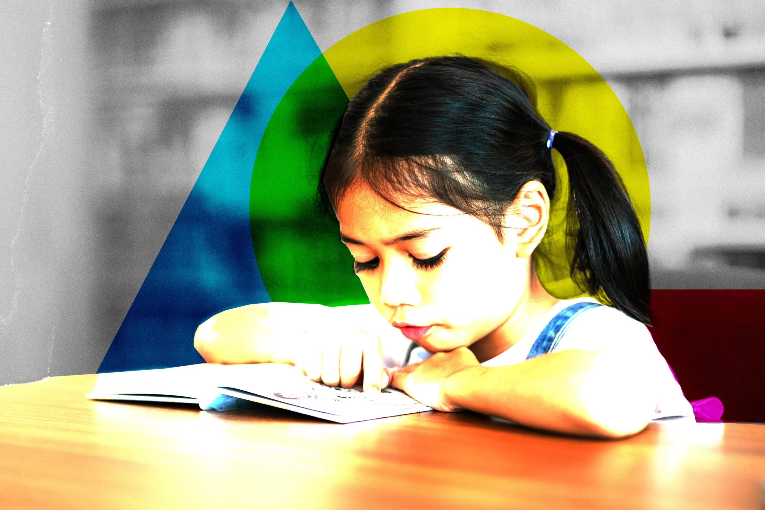A young girl is reading a book at a table. She is looking at the page and pointing at something. The scene is set in a library, with many books visible in the background