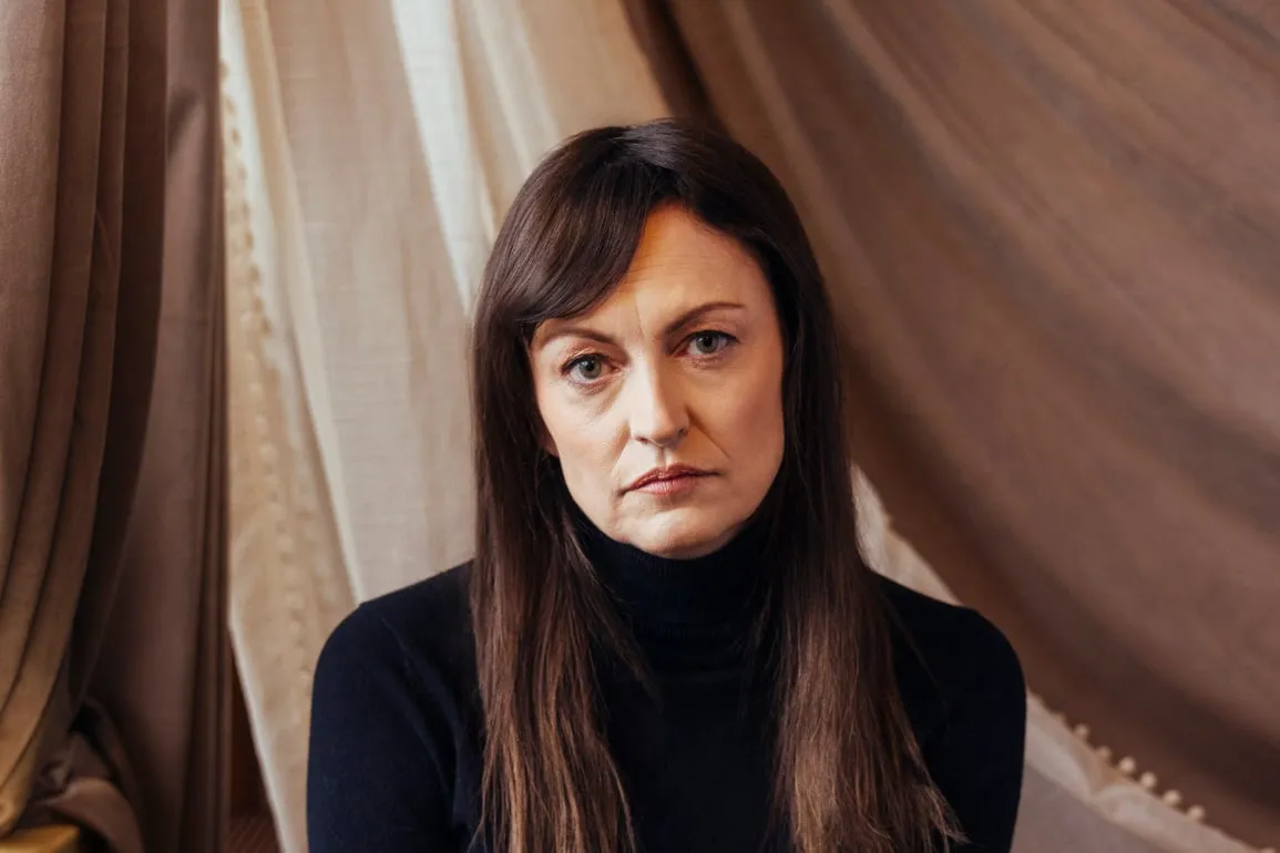 A woman with brown hair and bangs