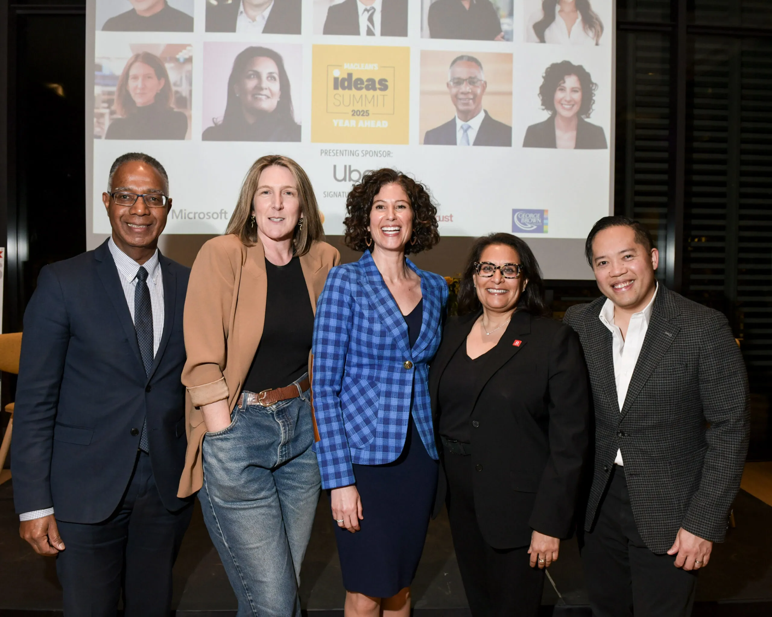 Dr. Gervan Fearon, Siri Agrell, Sevaun Palvetzian, Farah Mohamed and Jason Maghanoy pose for a picture in front of a stage and screen