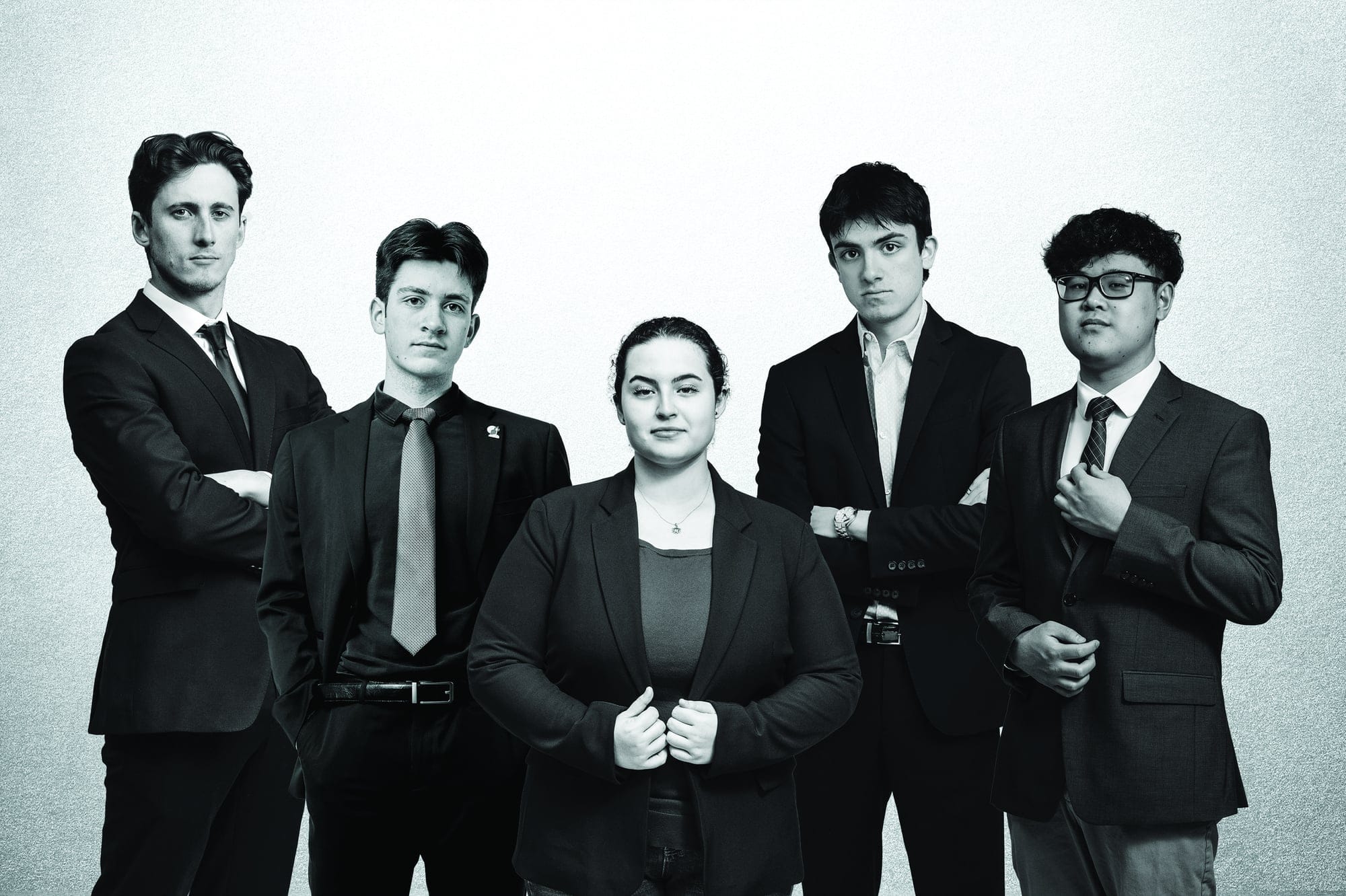 A gathering of five young people in businesswear