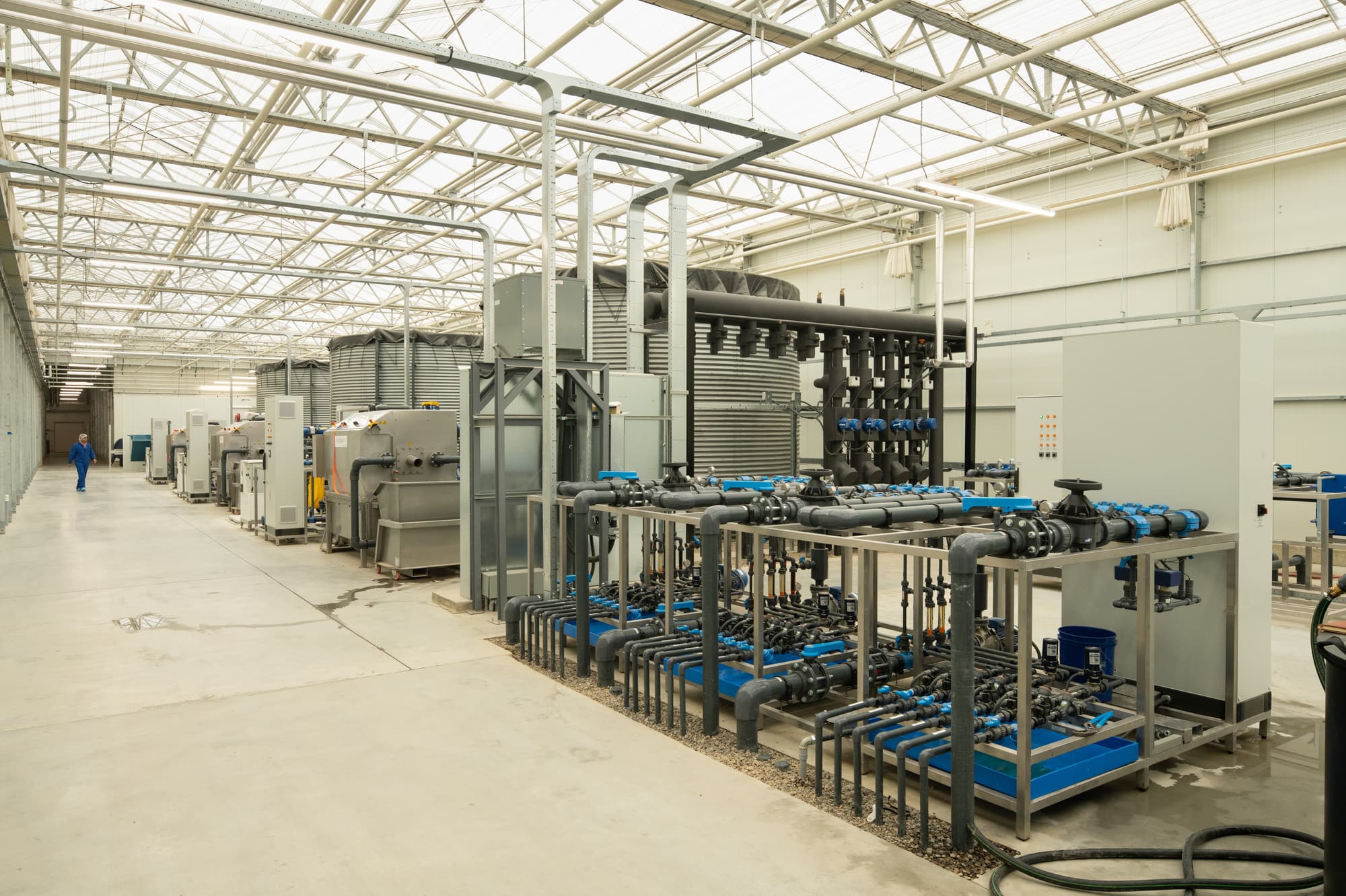 Industrial farming equipment sitting in a greenhouse