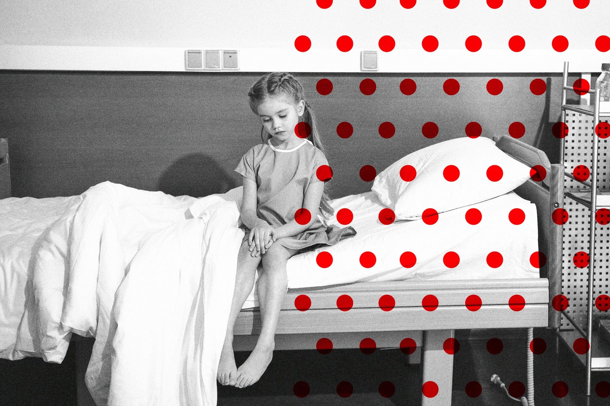 a child sitting on a hospital bed