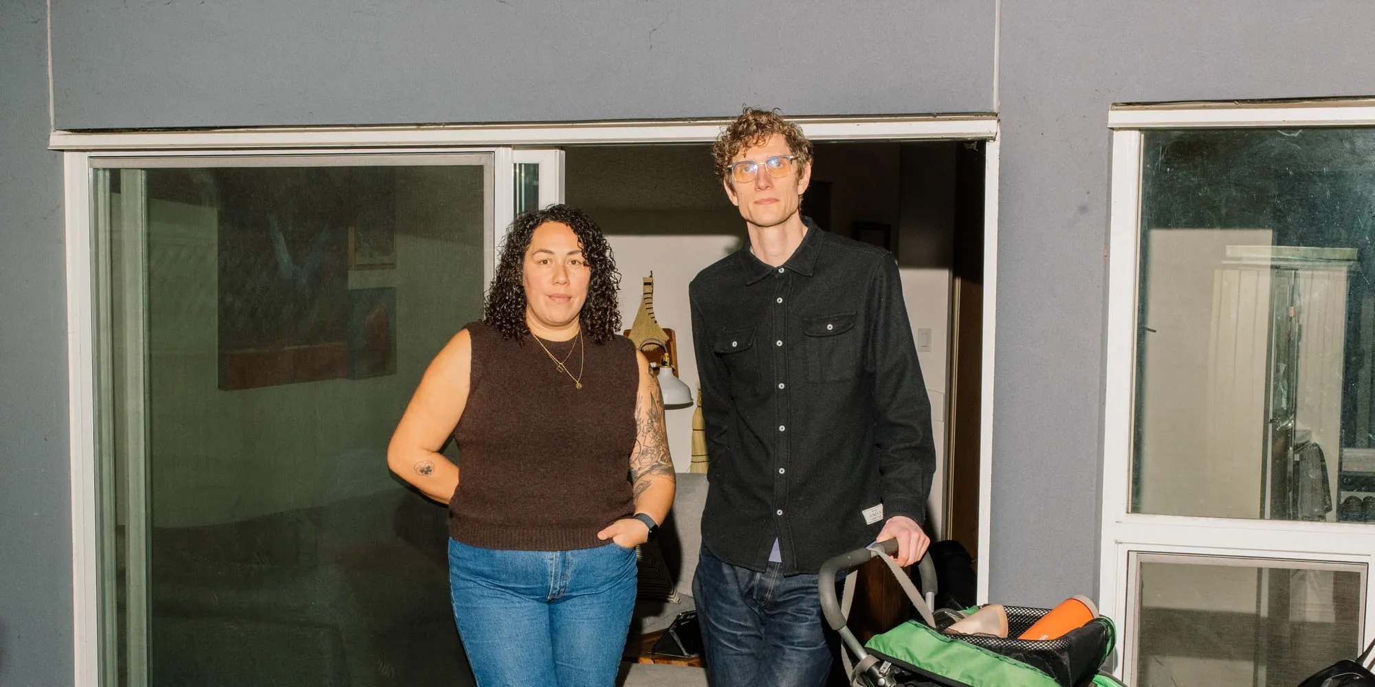 A woman in a brown shirt standing beside a man in a black button-up