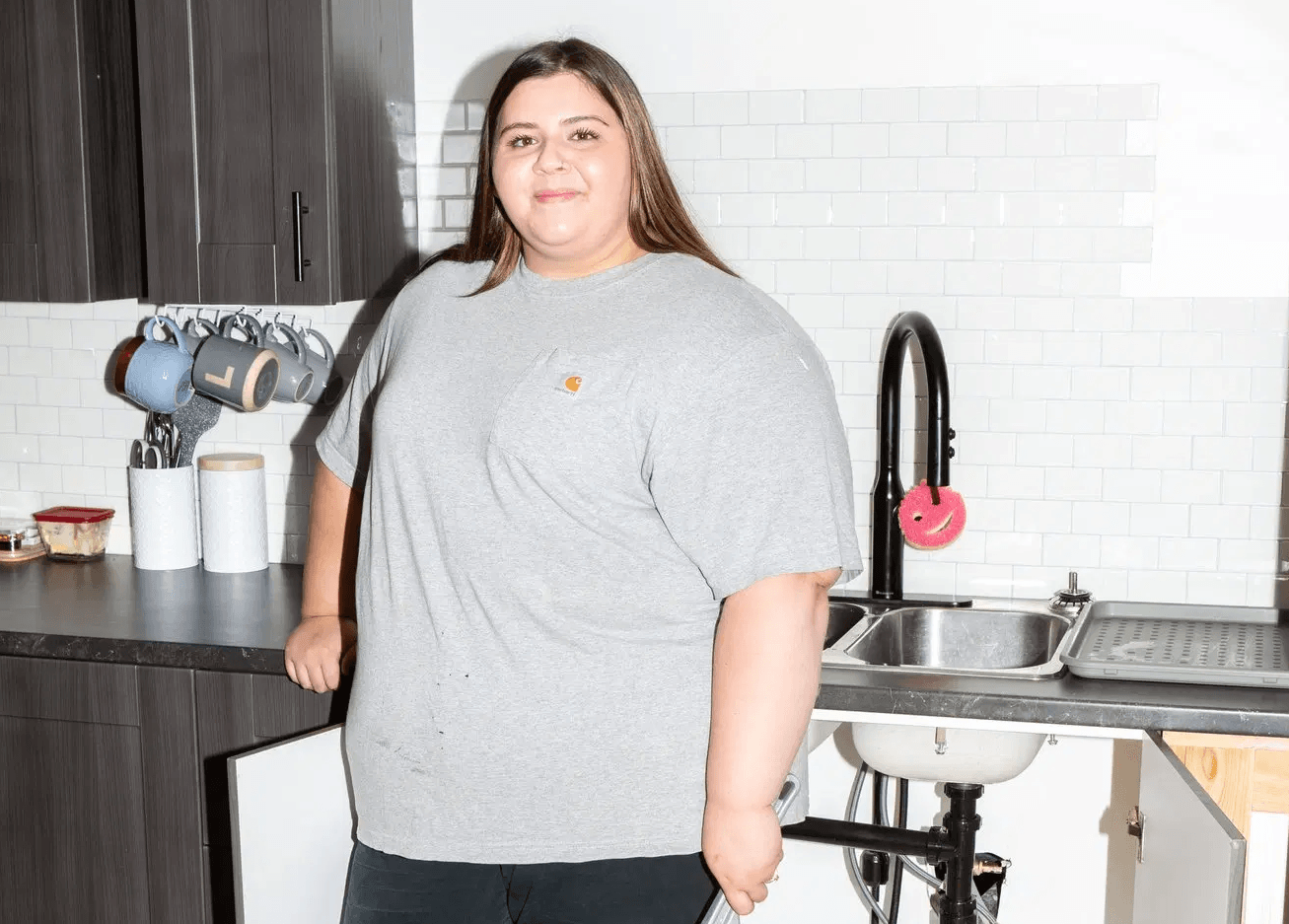 Portrait of Lauryn Chicoine standing in front of a sink