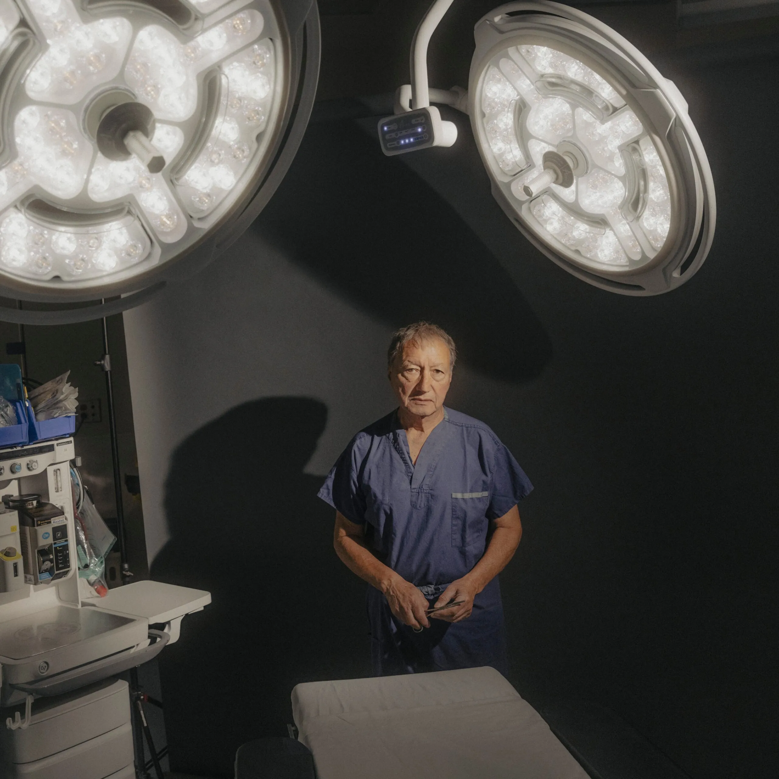 A man in scrubs standing in an operating room