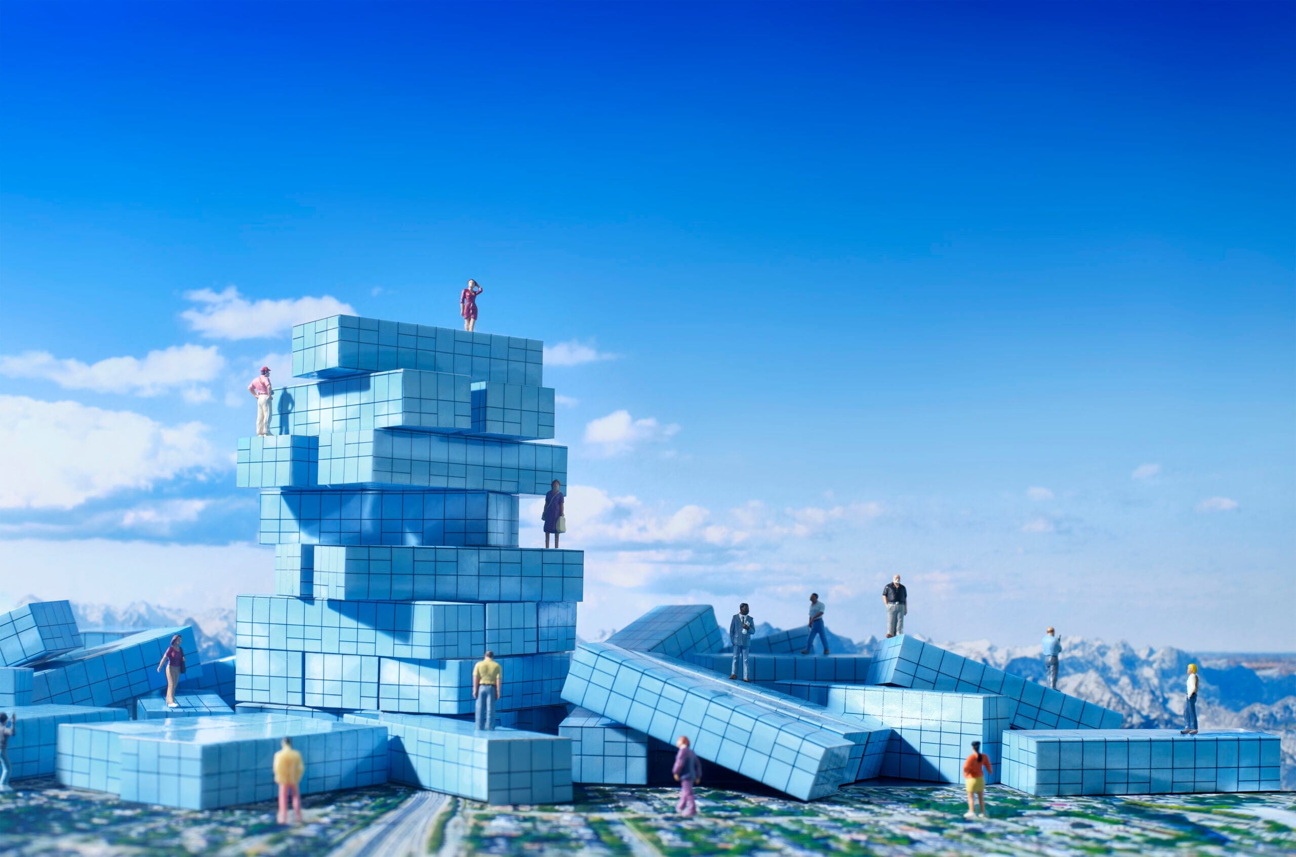 Illustration of people standing on top of condo-shaped building blocks.