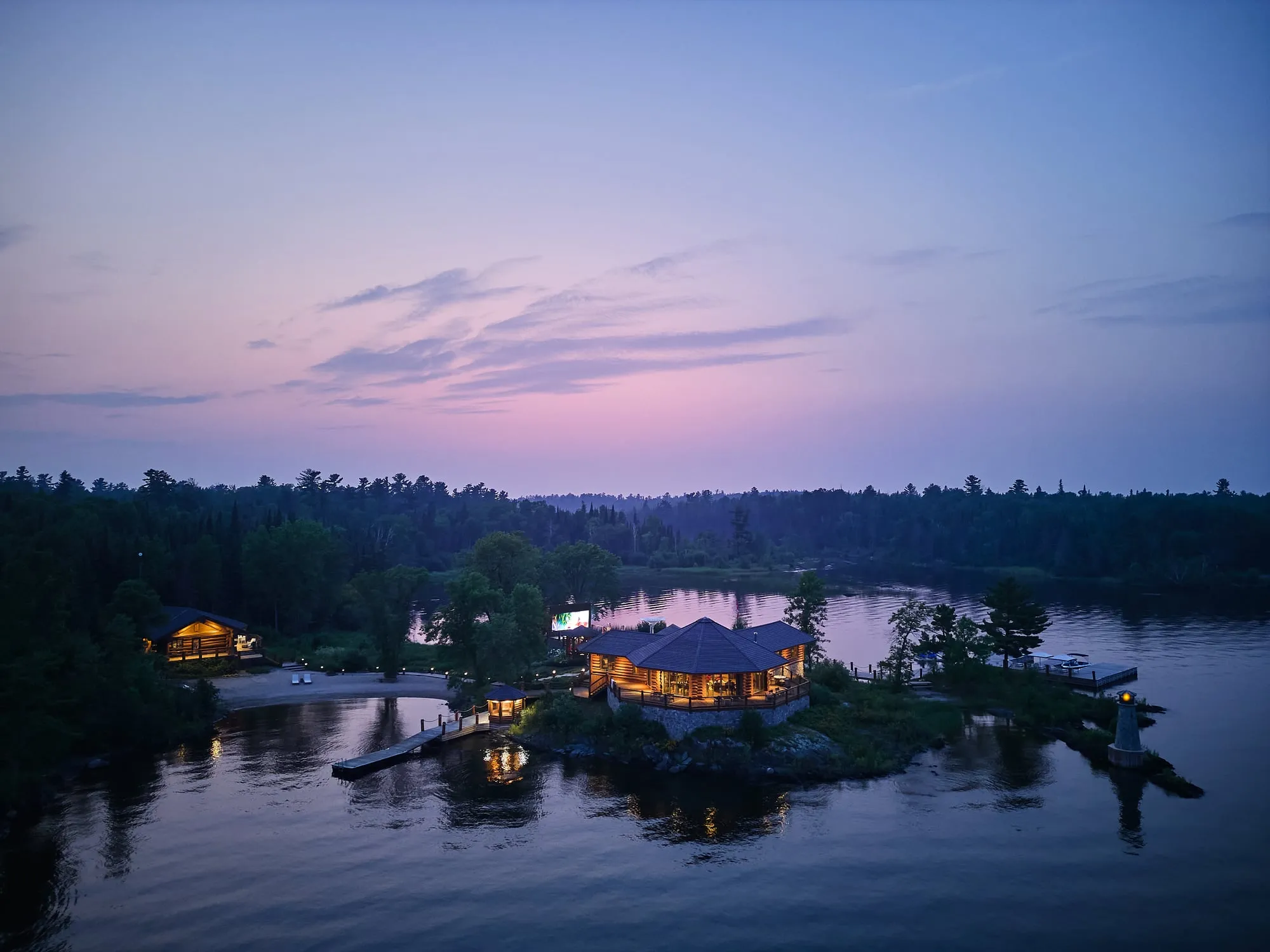 A purple-blue sunset over a lakeside residential property