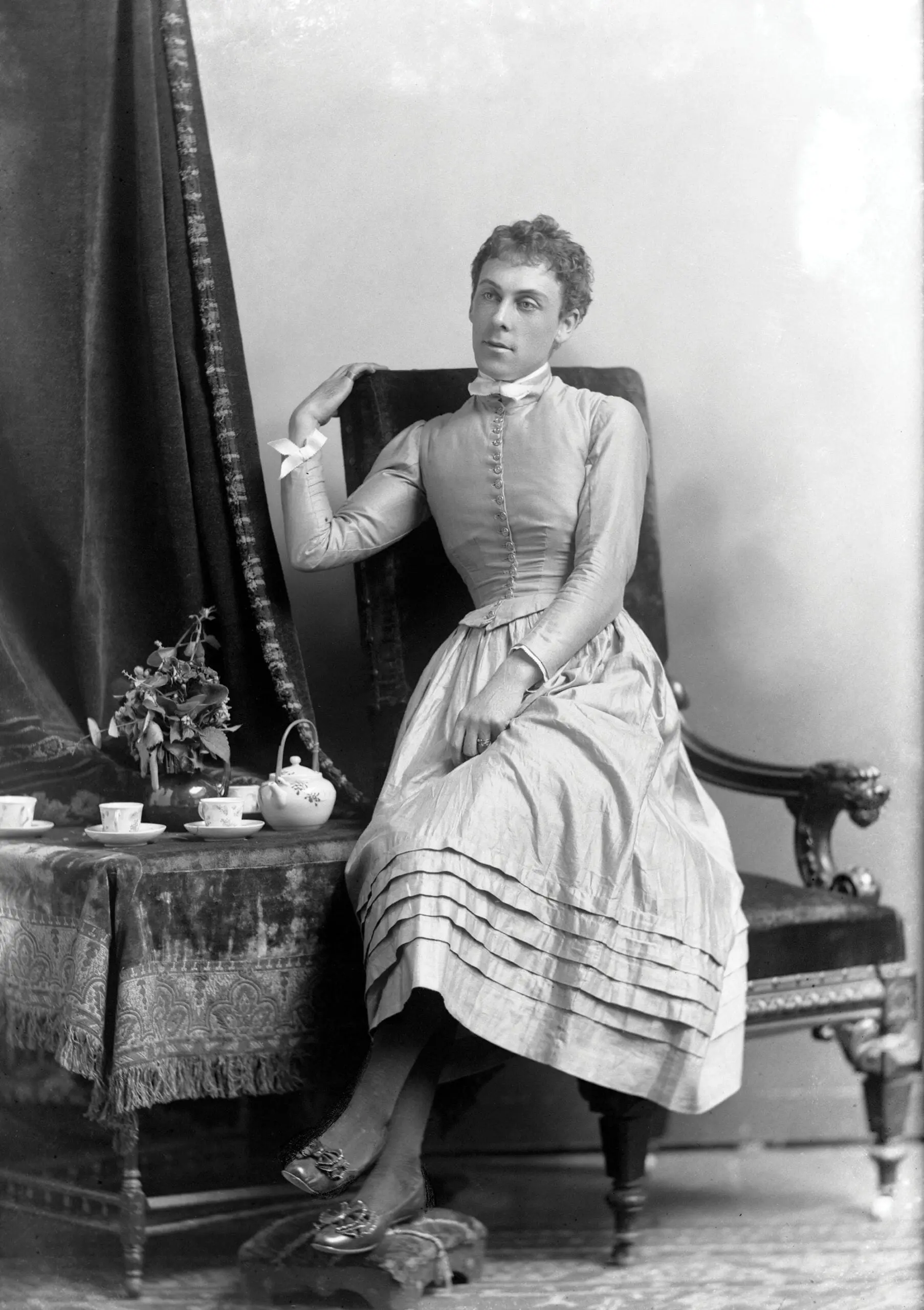 A woman in a dress sitting on a chair