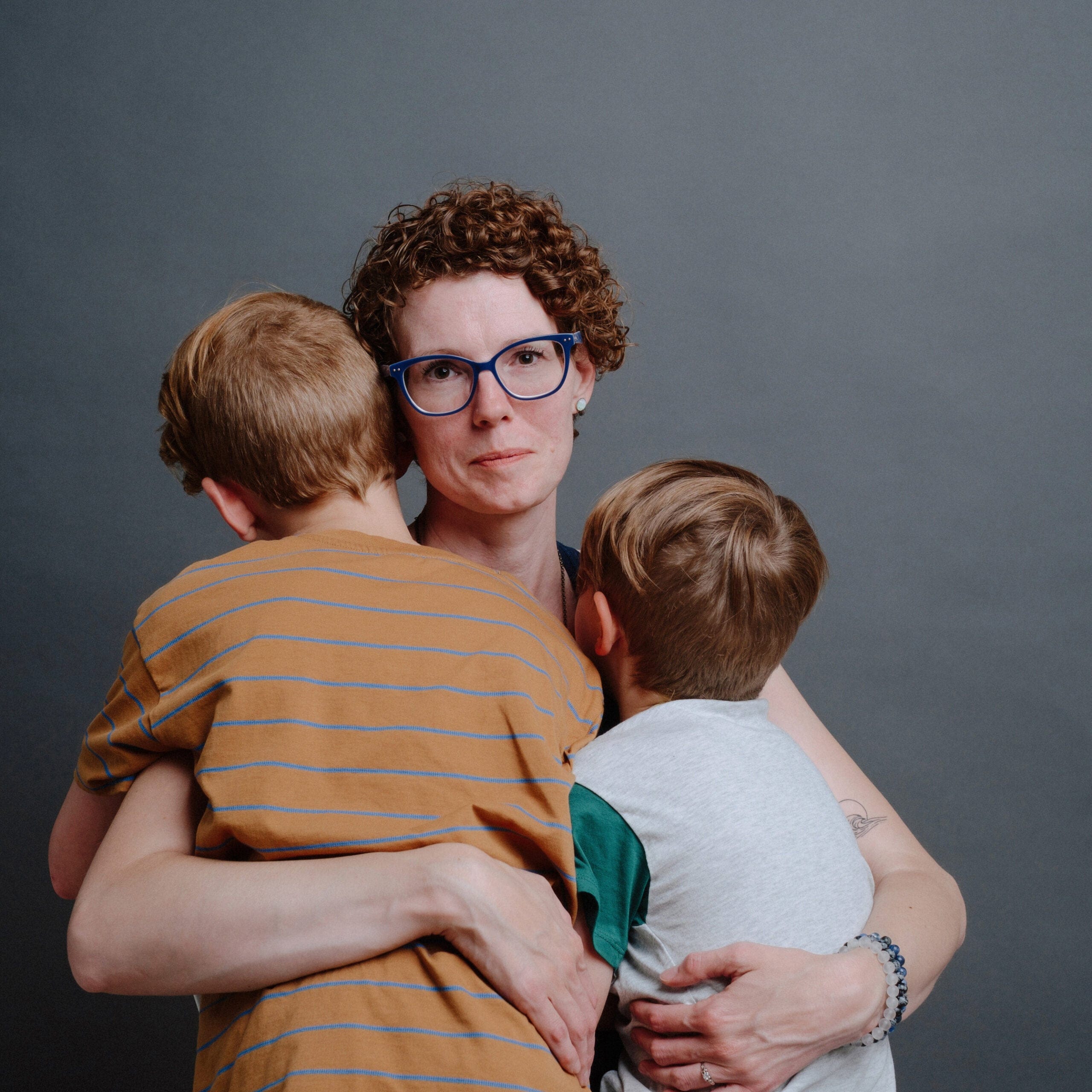 Mother holds her two little boys