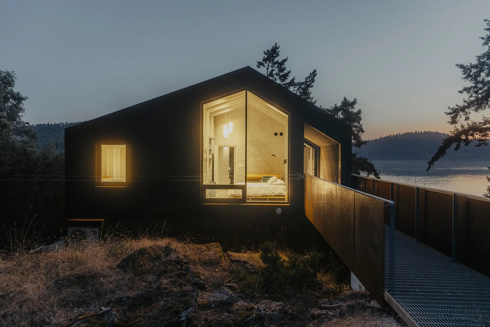 A cabin, glowing with yellow light from the inside