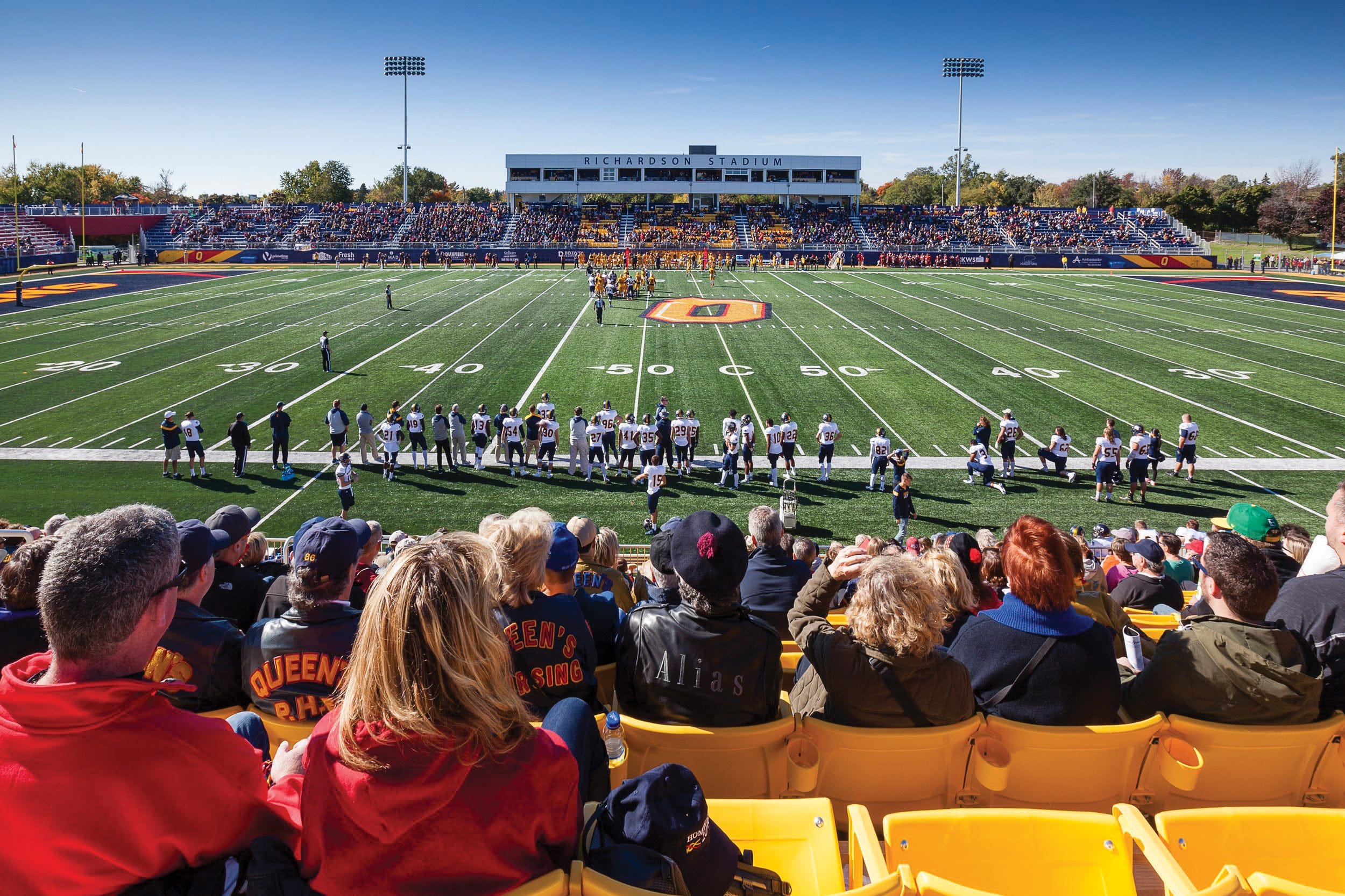 Students watching a football game from the bleachers