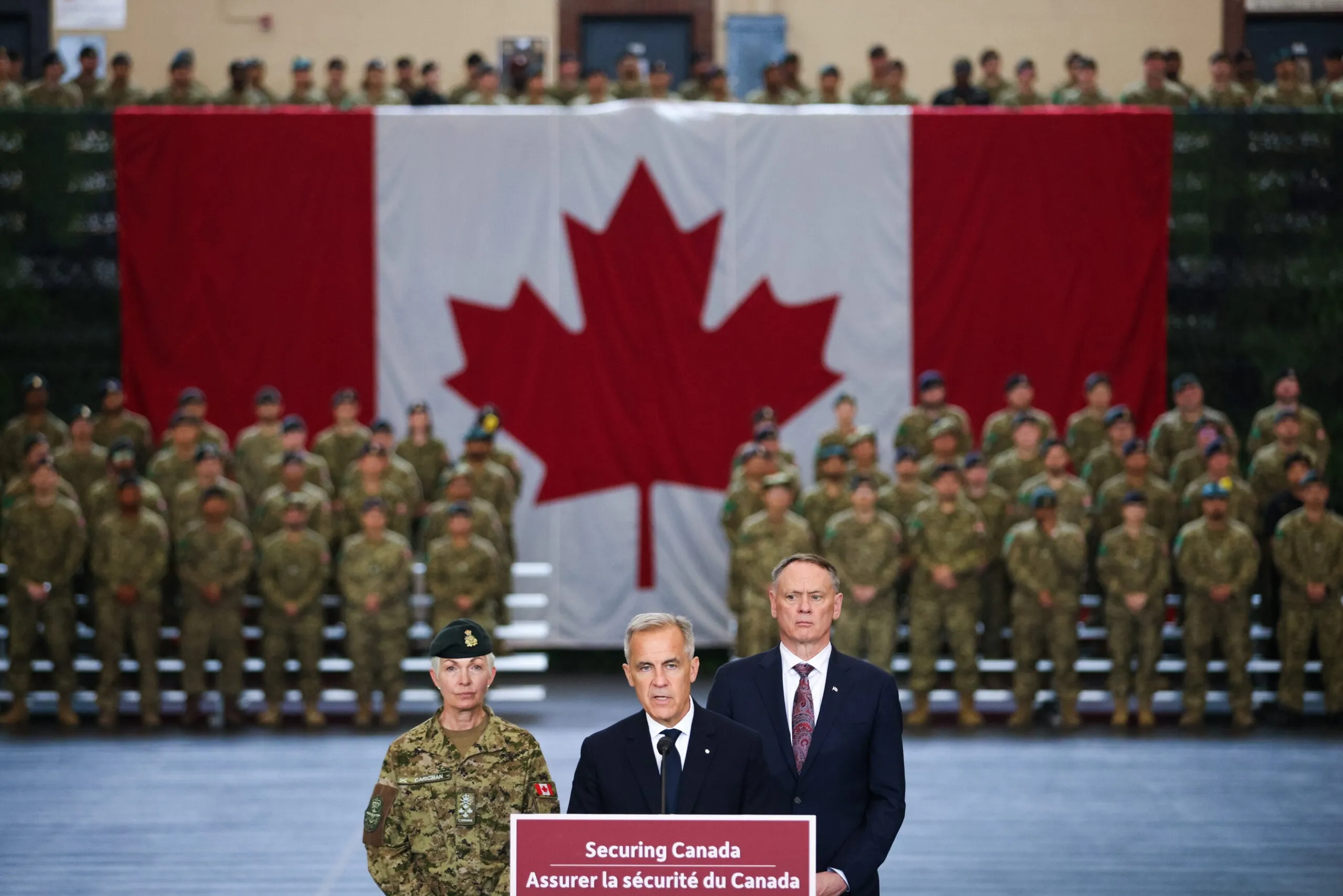 Mark Carney speaking at a podium