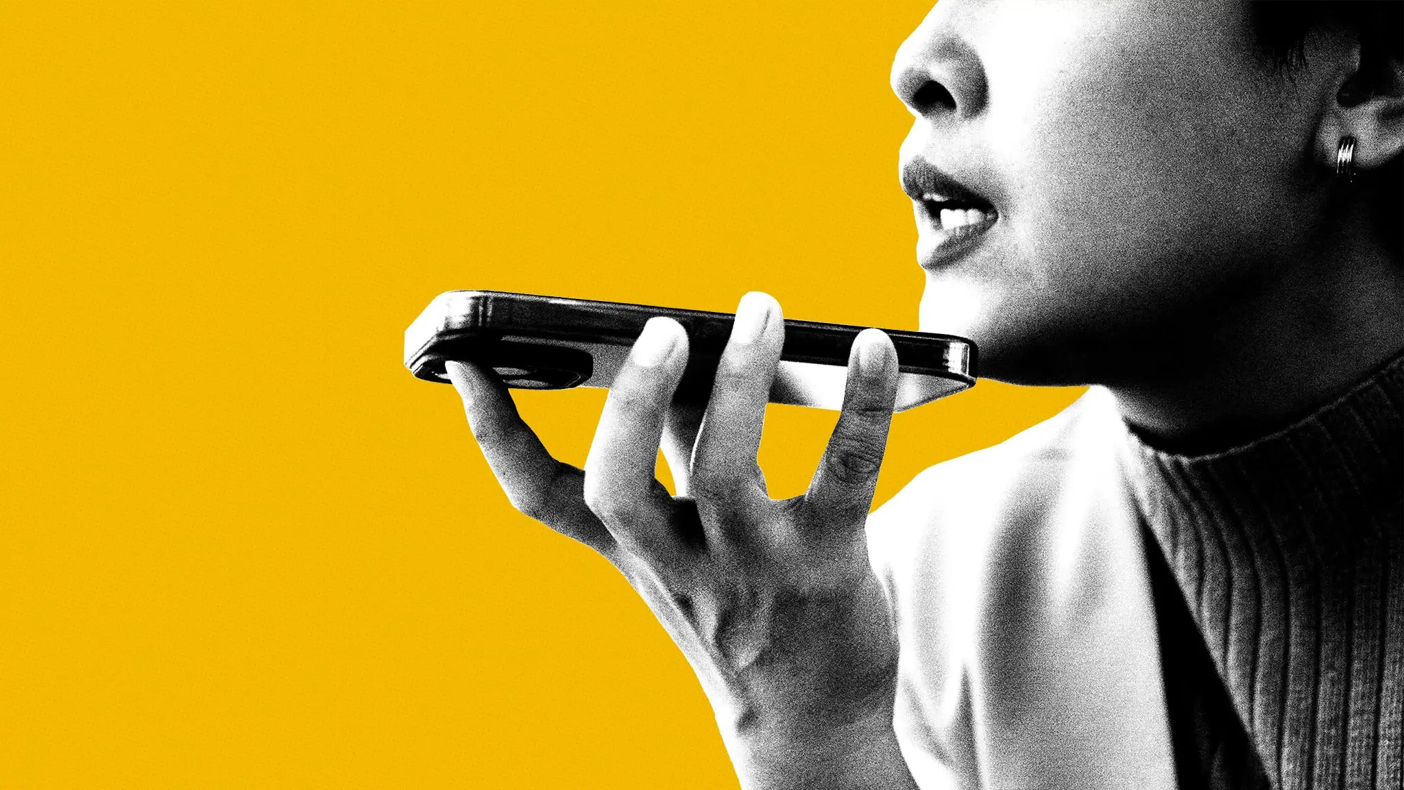 A close-up of a person speaking into a phone