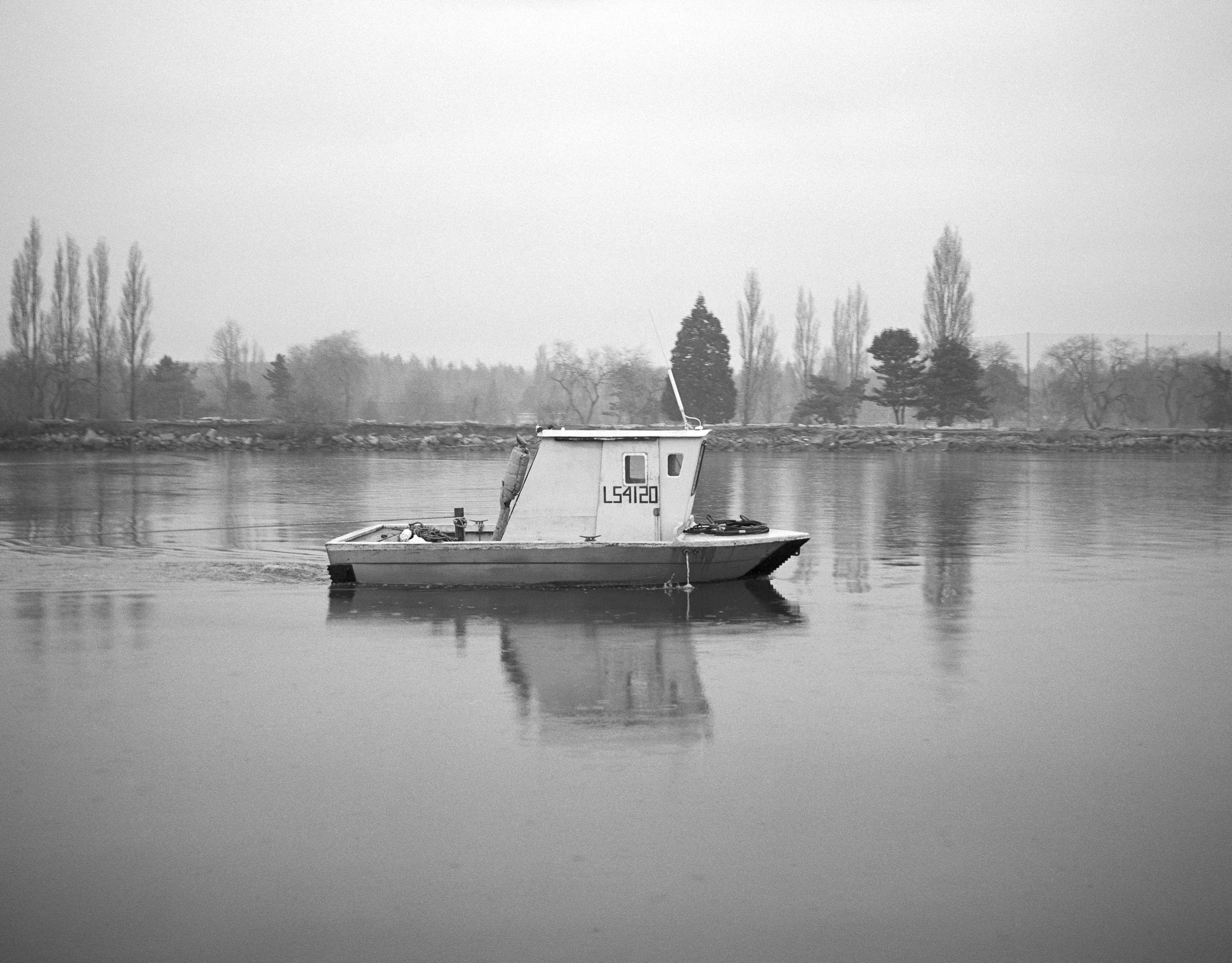 A small boat in the middle of a body of water