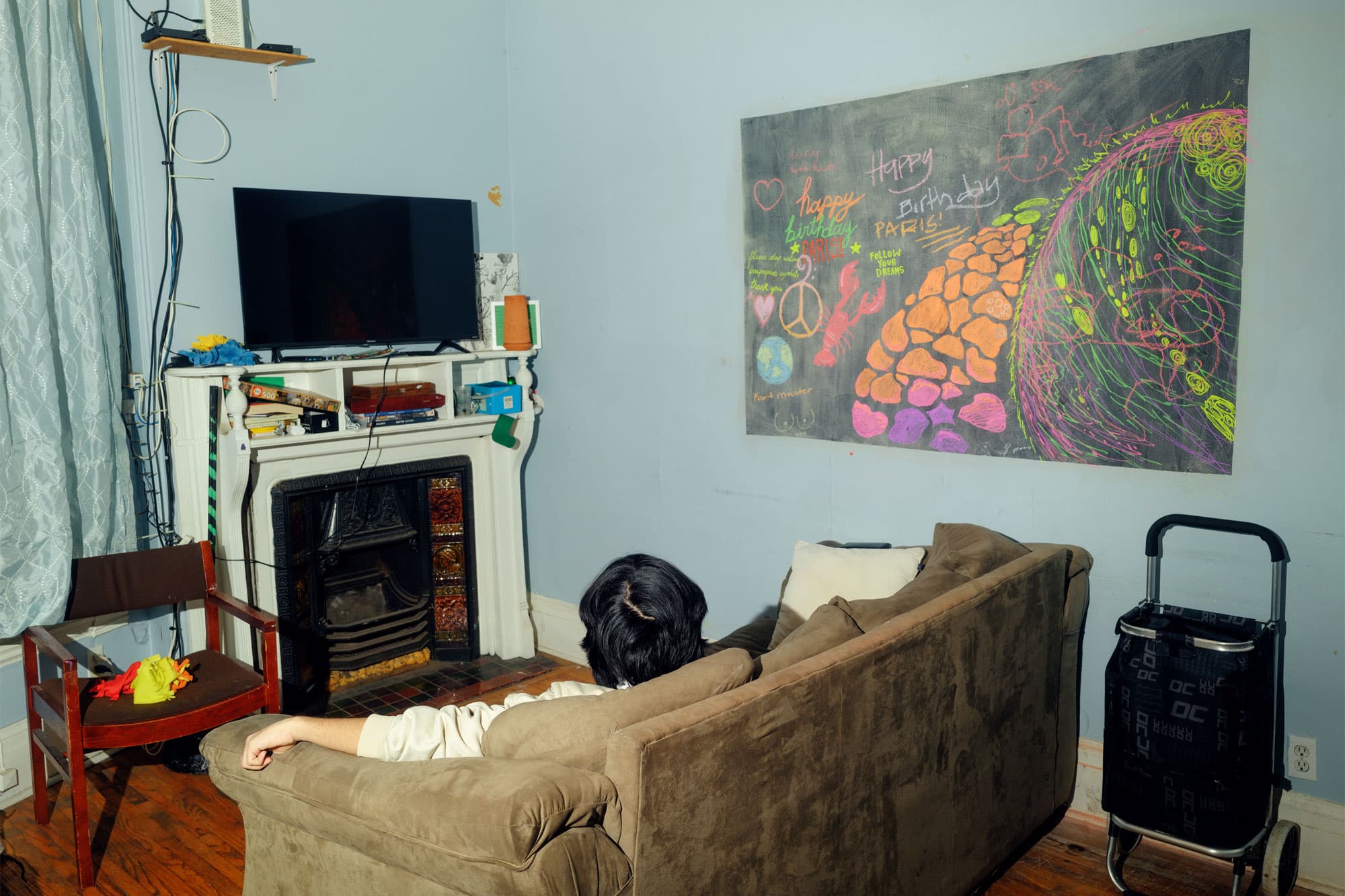 a student sitting in his living room