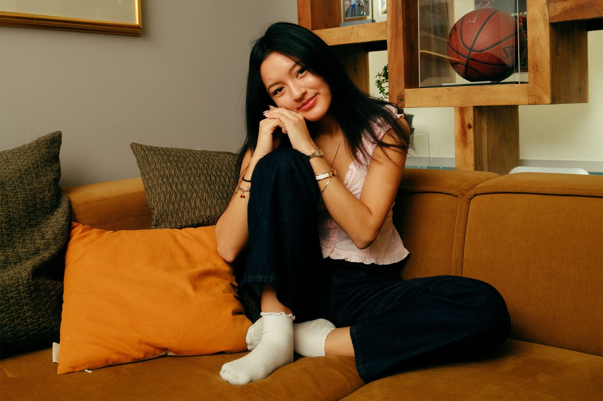 a college age student sitting on a couch at home