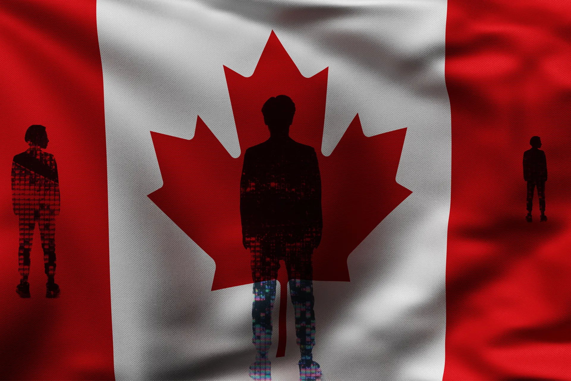 A silhoutted person standing in front of the Canada flag