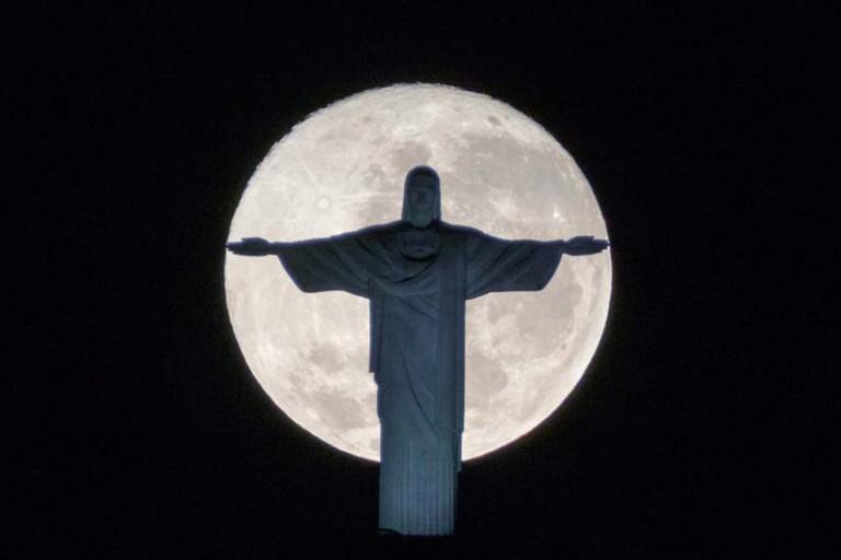 <p>The silhouette of the statue of Christ the Redeemer stands out against the full moon in Rio de Janeiro; the city needs all the prayers it can get in advance of the Summer Olympics (Yasuyoshi Chiba/AFP/Getty Images)</p>
