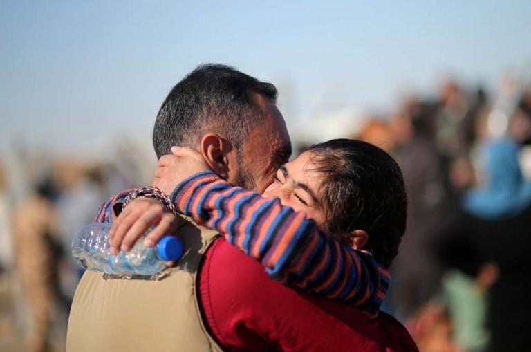 <p>Reunited: An Iraqi father and daughter, who separately fled the ISIS stronghold of Mosul, embrace at a refugee camp(Mohammed Salem/Reuters)</p>
