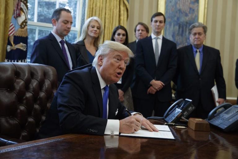 <p>President Donald Trump signs an executive order on the Keystone XL pipeline, Tuesday, Jan. 24, 2017, in the Oval Office of the White House in Washington. (AP Photo/Evan Vucci)</p>
