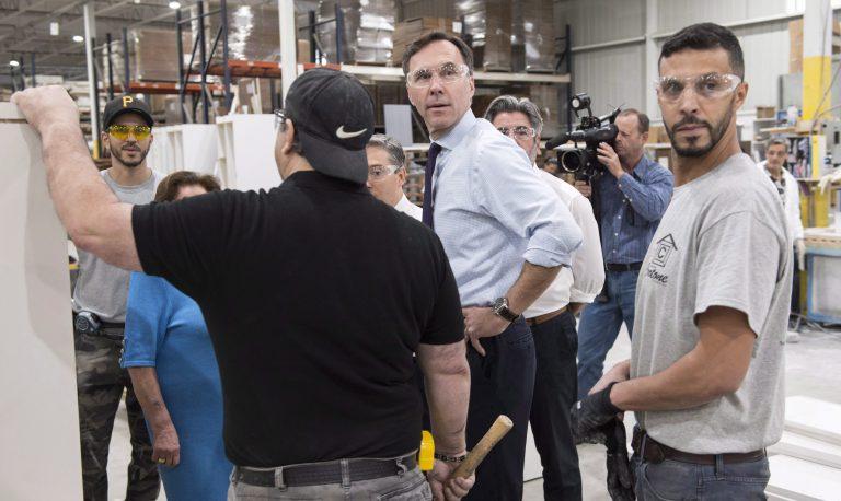 Bill Morneau with factory workers