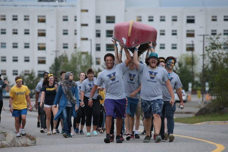 Laurentian University students carry a canoe