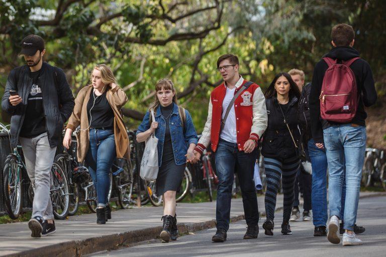 McGill students walking hand in hand on campus