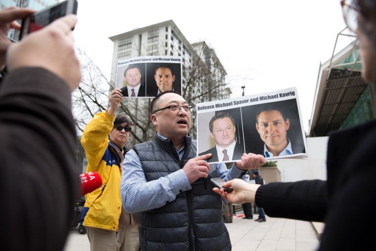 Louis Huang of Vancouver Freedom and Democracy for China holds photos of Canadians Michael Spavor and Michael Kovrig, who are being detained by China, outside British Columbia Supreme Court, in Vancouver, on March 6, 2019, as Huawei Chief Financial Officer Meng Wanzhou appears in court. - Meng Wanzhou, the Chinese telecom executive at the center of an escalating row between Ottawa and Beijing, was due in court in Canada to get a date for a hearing into a US extradition request. Meng's arrest in Vancouver in December on a US warrant infuriated China, which arrested several Canadians days later in what was widely seen as retaliation. (Jason Redmond /AFP/Getty Images)