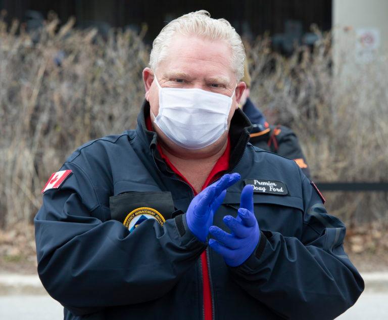 Ford applauds as he hands out prepared meals to front line health care workers at Scarborough Health Network hospital in Toronto on April 24, 2020 (CP/Frank Gunn)