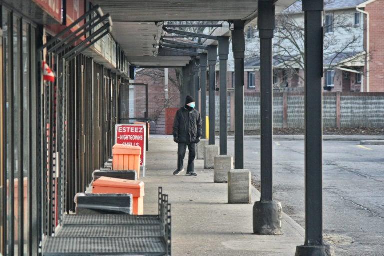 A man walks through an empty shopping plaza in Toronto on March 25, 2020 (Creative Touch Imaging Ltd./NurPhoto via Getty Images)