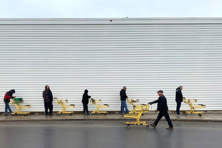 People use social distancing while they wait to get into the No Frills grocery store in Kingston, Ont. on Apr. 3, 2020. (Lars Hagberg/CP)