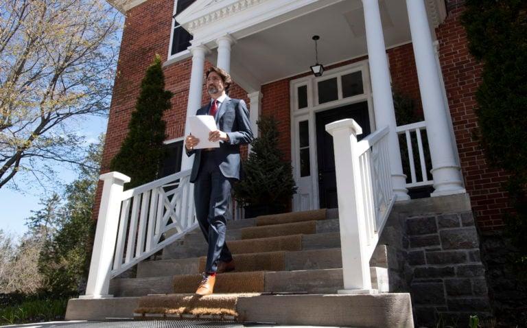 Prime Minister Justin Trudeau walks to the podium for a daily briefing outside Rideau Cottage in Ottawa, Thursday, May 14, 2020. THE CANADIAN PRESS/Adrian Wyld