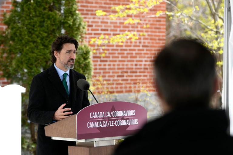 A reporter listens as Prime Minister Justin Trudeau speaks during his daily news conference on the COVID-19 pandemic outside his residence at Rideau Cottage in Ottawa, on Monday, May 11, 2020. THE CANADIAN PRESS/Justin Tang