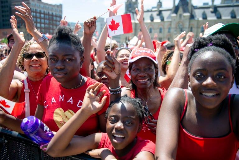 People cheer during the the Canada Day noon show on Parliament Hill in Ottawa on Monday, July 1, 2019. (Justin Tang/CP)