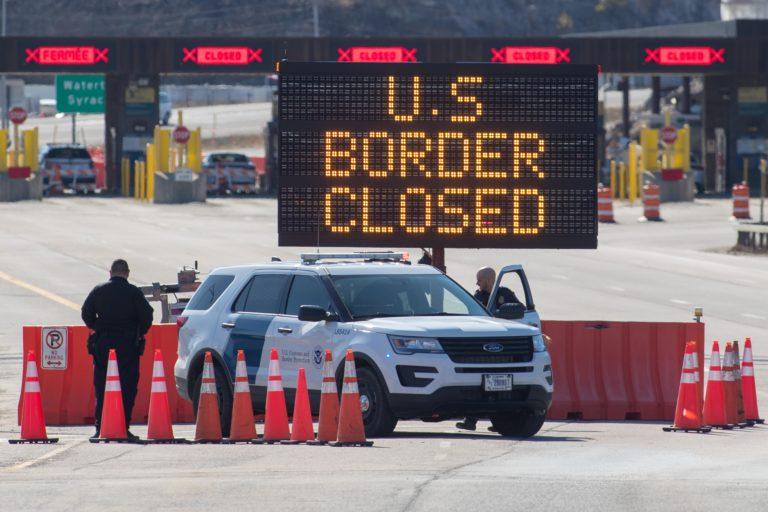 U.S. customs officers stand at the U.S.-Canada border in Lansdowne, Ont., on March 22, 2020 (LARS HAGBERG/AFP via Getty Images)