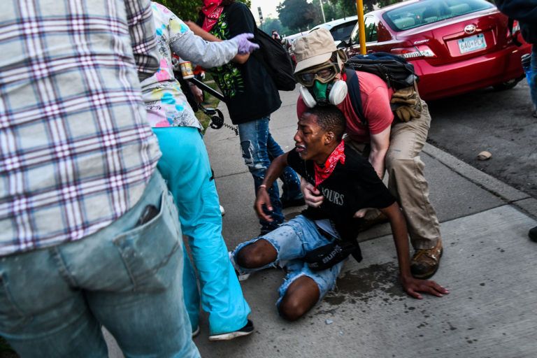 A protester in Minneapolis is helped by medics after being teargassed outside the city’s Fifth Precinct (Chandan Khanna/AFP/Getty Images)