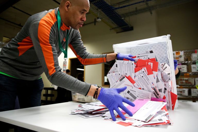 Election worker Erick Moss sorts vote-by-mail ballots for the presidential primary at King County Elections in Renton, Washington on March 10, 2020. (Jason Redmond/AFP/Getty Images)