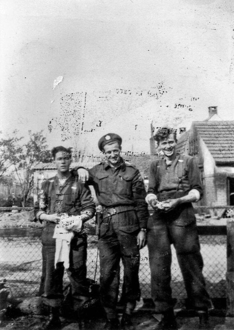Photograph of three soldiers from Queen's Own Rifles during World War II in Amersfoort, Netherlands. (Courtesy of Irene Martin)