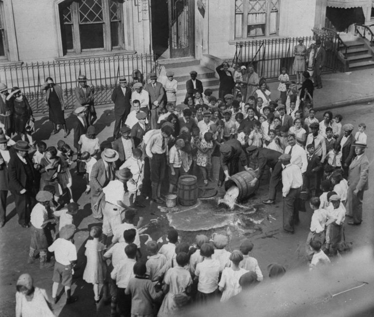 Beer is dumped into the street by police officers on Sep 13, 1929 after police discovered a home-brewed in a home. (NY Daily News Archive/Getty Images)