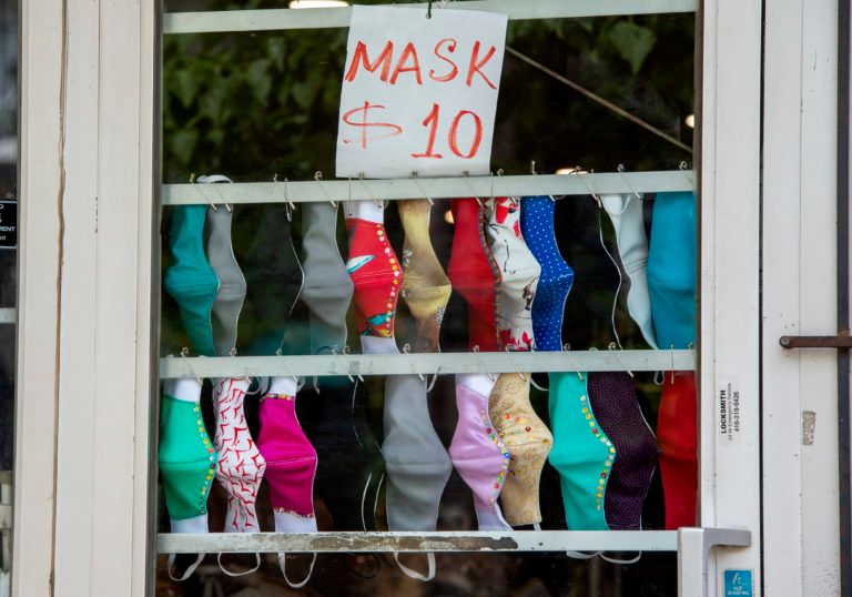 Masks hang on the door of a shop in Toronto on June 6, 2020 (CP/Frank Gunn)