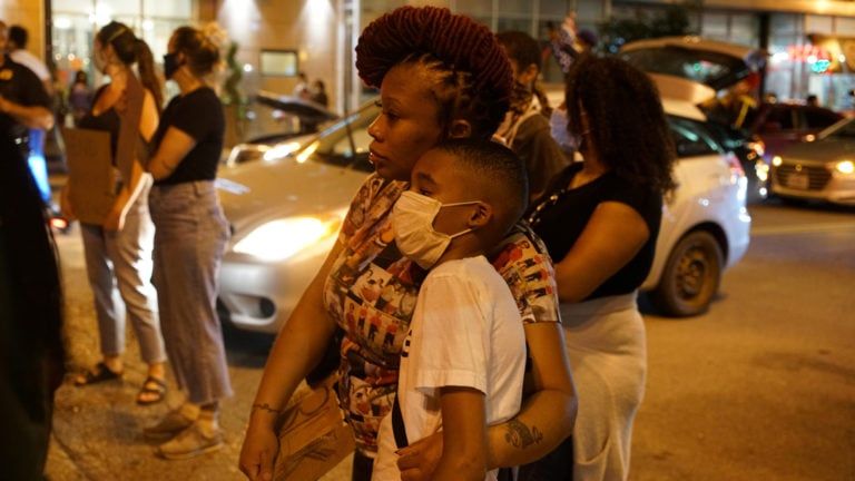 A woman embraces her son during a protest against the death in Minneapolis police custody of George Floyd, in St Louis, Missouri (Lawrence Bryant/Reuters)