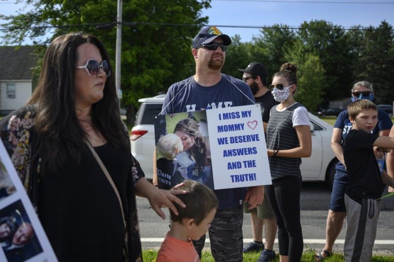 Nick Beaton, centre, wears a sign in memorial of his slain wife Kristen Beaton (Photograph by Darren Calabrese)